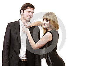 Woman helping man dress up elegant clothes.