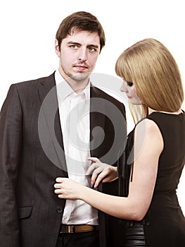 Woman helping man dress up elegant clothes.