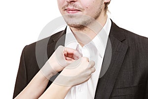 Woman helping man dress up elegant clothes.