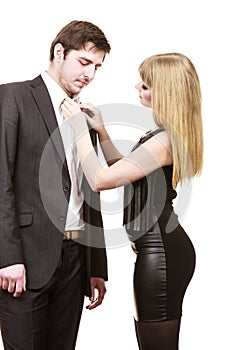 Woman helping man dress up elegant clothes.