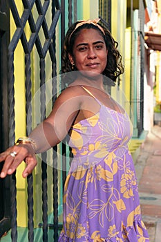 Woman in her 40`s in fashionable clothes posing in the street and smiling
