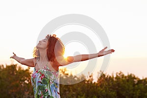 Woman with her arms outstretched in an expression of freedom