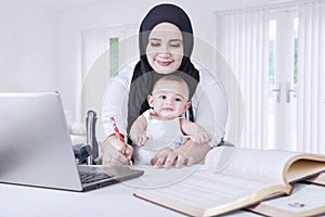 Woman with her Baby Working from Home