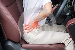 Woman with her back sprain while driving car long time, back body ache due to Piriformis Syndrome, Low Back Pain and Spinal