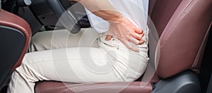 Woman with her back sprain while driving car long time, back body ache due to Piriformis Syndrome, Low Back Pain and Spinal