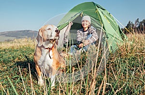 Woman in her beagle dog meet morning in touristic camping tent