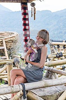 Woman with her beautiful beagle dog in nature of tropical Bali island, Indonesia. Travelling with dog concept.