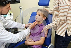 Woman with her child visiting otolaryngologist