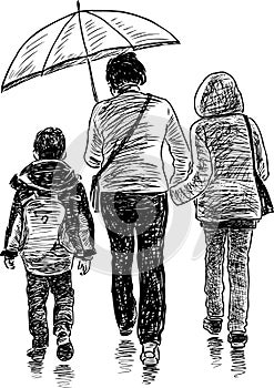 Woman with her children in the rain