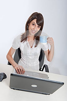 Woman at her desk with a mug