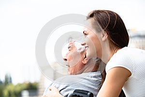 Woman With Her Disabled Father Near Railing