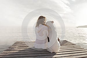 Woman and her dog admire together the view