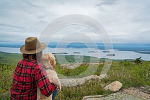 Woman and her dog look out over Mountain