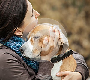 Woman with her dog tender hugs