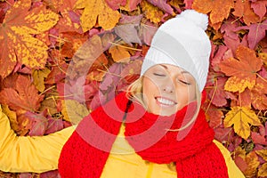Woman with her eyes closed laying in leafs