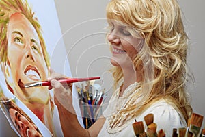 Woman in her fifties painting a portrait