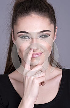 Woman with her finger up her nose