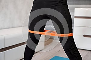 Woman during her fitness workout with rubber resistance band