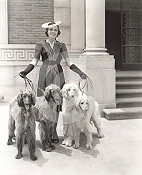 A woman and her four Afghan Hounds photo