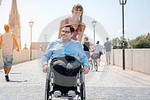 Woman and her friend in a wheelchair having stroll through the t