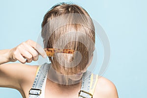 woman with her hair done. Close-up of a girl combing her hair