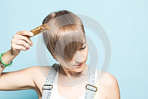 woman with her hair done. Close-up of a girl combing her hair