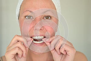 Woman fitting a mouth guard to protect her teeth photo