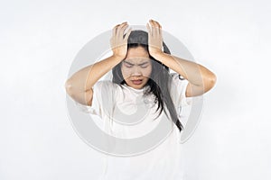 A woman with her hands on her head, looking very upset