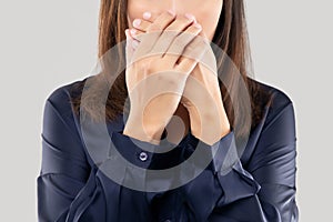 Woman with her hands on her mouth because of bad breath or halitosis photo