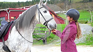 Woman with her horse in equestrian center