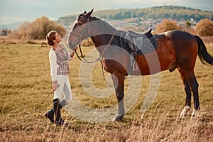 Woman with her horse at sunset, autumn outdoors scene