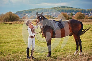 Woman with her horse at sunset, autumn outdoors scene