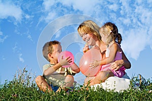 Woman and her kids playing