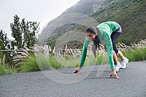 Woman, on her mark and start running for fitness, race or marathon with athlete training outdoor. Runner is ready for