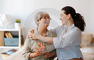 woman and her mother with flowers tulips