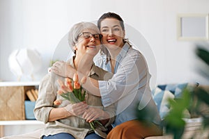 woman and her mother with flowers tulips