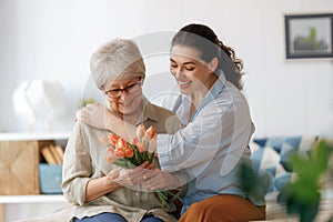 woman and her mother with flowers tulips