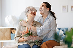 woman and her mother with flowers tulips