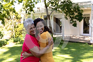 Woman and her mother standing in the garden