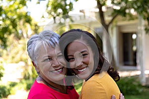 Woman and her mother standing in the garden