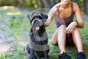 Woman and her pet dog enjoy time outdoors in the park, companionship