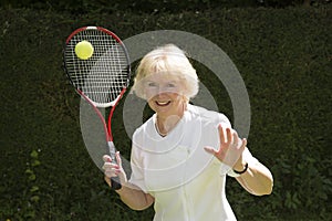 Woman in her sixties playing tennis