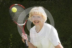 Woman in her sixties playing tennis