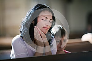 Woman with her son praying