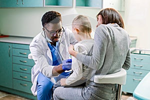 Woman with her son visiting children`s doctor in hospital