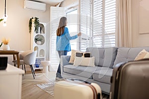 Woman with her suitcase in a rented apartment