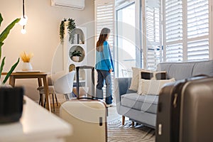 Woman with her suitcase in a rented apartment