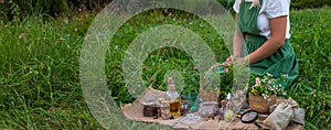 woman and herbal tinctures, tea, medicinal herbs.