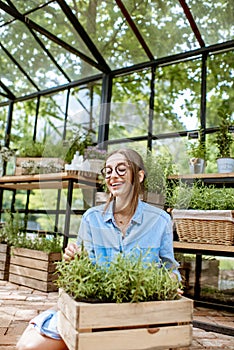 Woman with herbs in the greenhouse