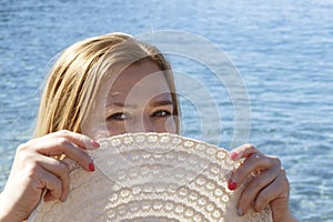 Woman hide face behind hat